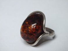 A LARGE SIZE SILVER & AMBER RING