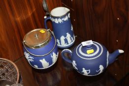 A WEDGWOOD BLUE DIP JASPERWARE TEAPOT, JUG AND CRACKER BARREL
