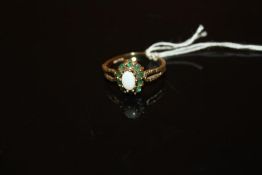 A 9 CARAT GOLD OPAL AND GREEN STONE DRESS RING - SIZE M - WEIGHT 1.9 GRAMS APPROX