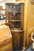A REPRODUCTION MAHOGANY GLAZED CORNER CABINET