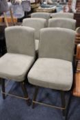 A SET OF SIX MODERN UPHOLSTERED SWIVEL BAR STOOLS