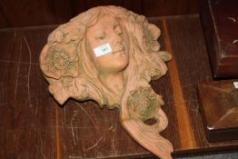 A TERRACOTTA STYLE OUTDOOR FIGURATIVE WALL POCKET