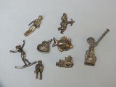EIGHT LARGE SILVER CHARMS