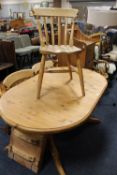 A PINE TWIN PEDESTAL EXTENDING DINING TABLE AND THREE CHAIRS
