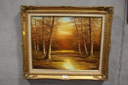 A GILT FRAMED OIL ON CANVAS DEPICTING A WOODLAND RIVER SCENE SIGNED H CORTEZ