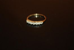 A HALLMARKED 9 CARAT GOLD SEVEN STONE LADIES DRESS RING - SIZE N 1/2 - WEIGHT 1.1 GRAMS APPROX
