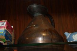 A VINTAGE COPPER 1 GALLON MEASURING JUG