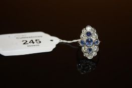 A SAPPHIRE AND DIAMOND RING, set with ten brilliant cut diamonds and five sapphires, hallmarks