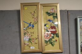 A PAIR OF GILT FRAMED AND GLAZED ORIENTAL PAINTINGS ON SILK DEPICTING BIRDS