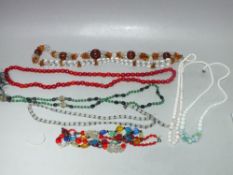 SEVEN VINTAGE GLASS NECKLACES