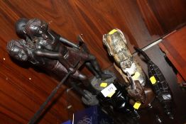 A TRIBAL STYLE EBONISED TREEN FIGURE GROUP TOGETHER WITH THREE CARVED SMALL BUSTS ETC