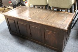 AN OAK PANELLED COFFER, W 126 CM
