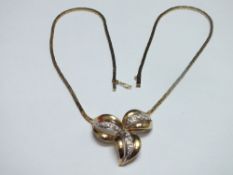 A 14CT GOLD AND GEMSET NECKLACE, the flat link chain with fixed central gemset floral panel, stamped