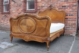 AN ANTIQUE 19TH CENTURY FRENCH WALNUT BED FRAME, with typical Rococo carved detail, with mattress, W