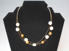 A LADIES DESIGNER 18CT GOLD PEARL AND DIAMOND THREE STRAND NECKLACE, together with a pair of