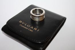 A BVLGARI 18CT WHITE GOLD SPRUNG DIAMOND RING, the sprung ring set with four bands of pave set
