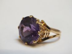 A CONTINENTAL STYLE DRESS RING, marks indistinct, set with a purple stone, approx weight 7.5g, ring