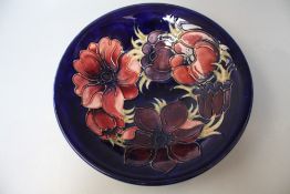 A MOORCROFT ANEMONE PATTERN CIRCULAR FOOTED BOWL, blue ground with typical tubelined decoration,