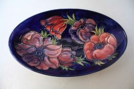 A MOORCROFT ANEMONE PATTERN OVAL DISH, blue ground with typical tubelined decoration, impressed