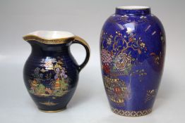 A VINTAGE CROWN DEVON CREAM JUG, blue ground with gilded decoration of an Oriental garden, H 14