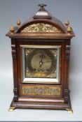 AN EARLY 20TH CENTURY OAK CASED MANTEL CLOCK BY LENZKIRCH, the architectural case with decorative
