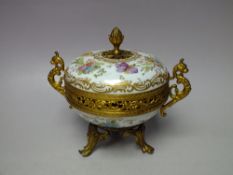 A GILT AND PORCELAIN POT POURRI /LIDDED TRINKET, the circular porcelain body with hand painted