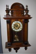 AN ANTIQUE WALNUT CASED VIENNA WALLCLOCK OF SMALL PROPORTIONS, the case decorated with painted