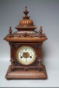 AN EARLY 20TH CENTURY WALNUT 'GREENWICH' MANTEL CLOCK BY W E WATTS, the architectural case topped