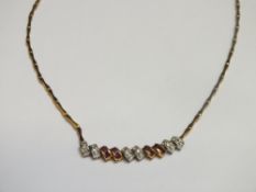 A RUBY AND DIAMOND NECKLACE, set in unmarked yellow metal, approx weight 19.2g