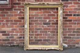 A 19TH CENTURY GOLD SWEPT FRAME WITH INTEGRAL SLIP A/F, frame W 10 cm, rebate approx 113 x 87 cm
