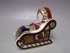 A ROYAL CROWN DERBY SANTA AND SLEIGH CHRISTMAS PAPERWEIGHT, silver stopper, with associated box, L