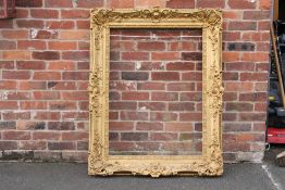 A 19TH CENTURY DECORATIVE GOLD SWEPT FRAME, frame W 14 cm, rebate approx 114 x 79 cm