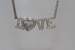 A CHOPARD 18CT WHITE GOLD 'HAPPY LOVE' NECKLACE, diamond weight 0.72ct