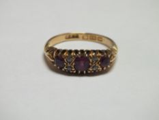 AN 18CT GOLD GEM SET DRESS RING, the three larger pink gemstones set with two rows of two diamonds