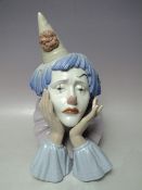 A LLADRO BUST OF A CLOWN, head in hands, H 30 cm