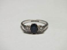 A SAPPHIRE AND DIAMOND THREE STONE RING, the brilliant cut diamonds being an estimated 10pts each,