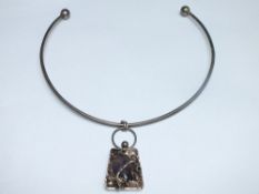 A STERLING SILVER AND AMETHYST DESIGNER PENDANT BY WIGGERS OF DENMARK, on a white metal