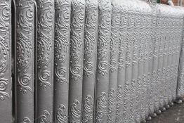 FOUR LENGTHS OF ROCOCO STYLE CAST IRON RADIATOR SECTIONS, each radiator section with interwoven