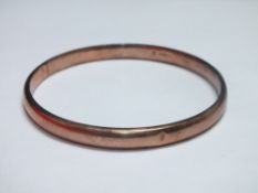 AN ANTIQUE YELLOW METAL BANGLE STAMPED .375, internal Dia.7.5 cm, approx weight 10.4 g