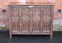 AN ANTIQUE OAK JACOBEAN STYLE DEEP COFFER, the hinged lift-up lid above a carved and