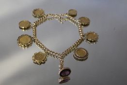 A 9CT GOLD ROLLER CHAIN SET WITH AN ORNATE AMETHYST SEAL AND EIGHT ASSORTED GOLD COINS, comprising f