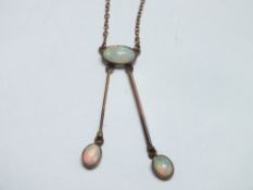 AN EARLY 20TH CENTURY 9CT GOLD OPAL PENDANT / DROPPER NECKLACE, with single central opal and two 9ct
