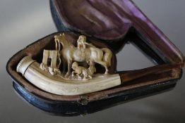 A CARVED MEERSCHAUM PIPE, carved with dogs playing around a horse, W 14.5 cm