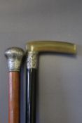 TWO WALKING CANES, one silver topped malaca and the other a silver banded horn handled example, A/F,