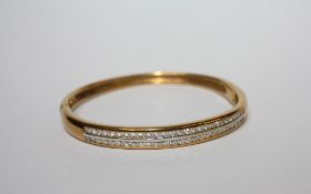 AN 18CT GOLD AND DIAMOND BANGLE, set with two rows of diamonds, diamond weight 2.00ct, weight 30.3