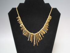 A ROBERTO COIN 18CT HALLMARKED 750 AND DIAMOND 'FRINGE' DESIGN COLLARETTE, in yellow and white gold,