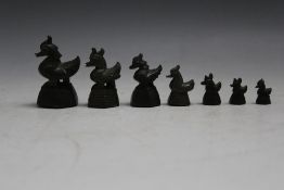 A GRADUATED SET OF SEVEN ORIENTAL CAST BRONZE OPIUM WEIGHTS IN THE FORM OF DUCKS, tallest 5.5 cm