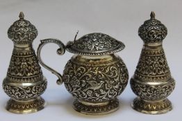 A GOOD QUALITY INDIAN SILVER THREE PIECE CRUET SET BY OOMERSI MAWJI, court silversmith to The