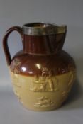 A VICTORIAN SALT GLAZE STONEWARE JUG WITH HALLMARKED SILVER RIM, the jug decorated in relief with