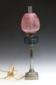 A TALL SILVER PLATED STEPPED COLUMN OIL LAMP, with decorated etched shade, converted to electrical
